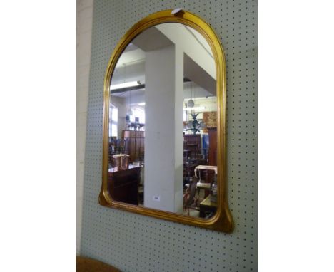 A decorative gilt framed over mantel mirror.