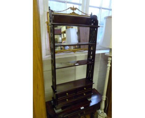 A reproduction mahogany Chippendale style hanging shelf unit, have four base drawers.