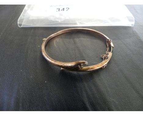 A 9K gold snake bangle, the hinged bangle with pink stone eyes, stamped .375, approx. weight 5g.