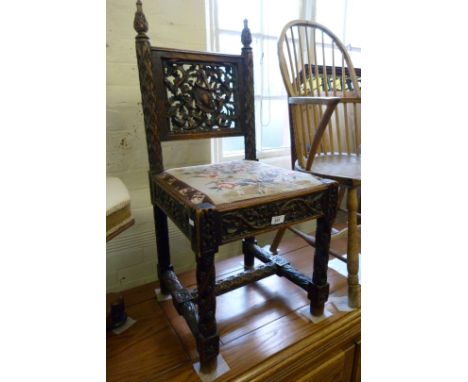 A good quality decorative Flemish style hall chair, having carved and pierced decoration, upholstered in a tapestry seat cush