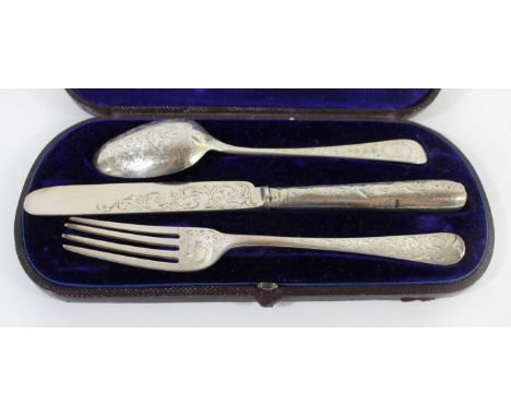 A Victorian silver christening setComprising a fork, knife and spoon with scrolling decoration in a fitted case, John Gilbert