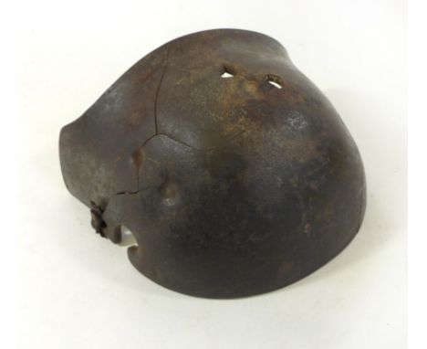An Imperial German WWI M16 helmet Stirnpanzer steel snipers brow plateThe plate with numerous bullet marks and three holes th