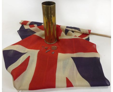 A British Union Jack, mid 20th CenturyThe 70x130cm Union Jack on a wooden pole, brass WWI period shell case, the 29cm high sh