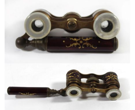 A pair of early 20th Century enamel and mother of pearl opera glassesWith side handle and decorated with gilt motifs on a mar