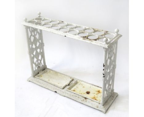 A Victorian white painted cast iron umbrella and stick standOf rectangular form, fitted with two drip trays and decorative pi