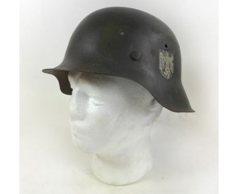 A WWII Nazi Germany Infantry steel painted helmetHelmet with decal of an eagle and swastika, complete with leather lining, th