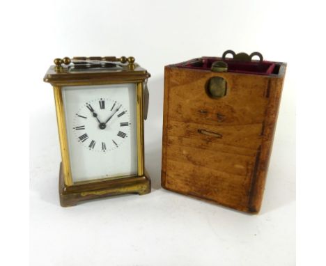 A early 20th Century brass framed carriage clockWith white enamel dial and Roman numerals and brass movement unsigned, height