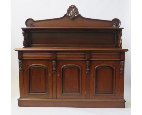 A mahogany chiffonier The back with single shelf and moulded shell detail, over pierced side supports, the base section with 