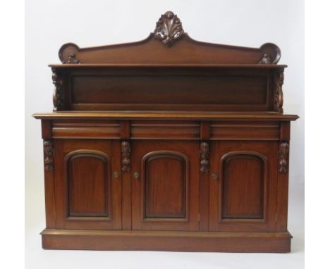 A mahogany chiffonier The back with single shelf and moulded shell detail, over pierced side supports, the base section with 