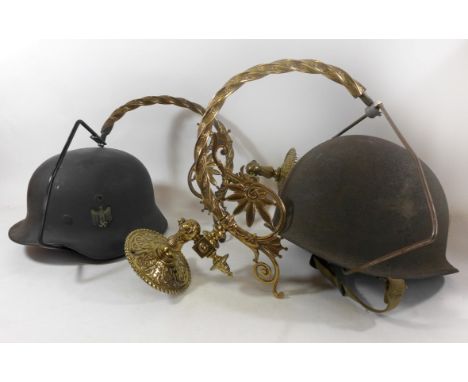 A pair of novelty military helmet wall lights, early 20th Century and laterThe Edwardian brass fittings with later mounted he