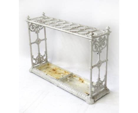 A Victorian white painted cast metal umbrella and stick standWith two drip trays and decorative pierced ends, height 65cm, wi