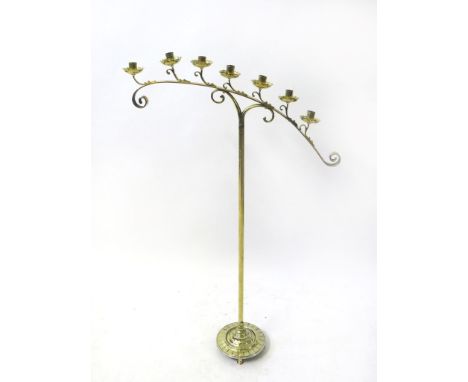 A late 19th/early 20th Century brass freestanding seven light candlestickRaised on plain stem and circular base, height 115cm