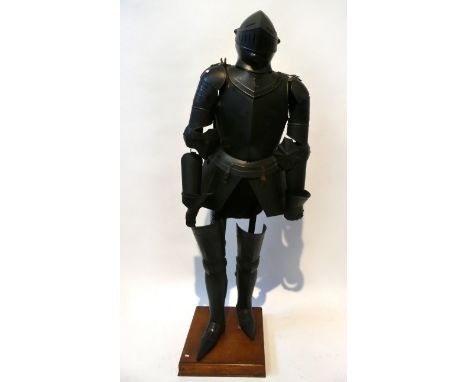 A reproduction 15th Century style black painted articulated suit of armourComplete with helmet and gauntlets, mounted on an o