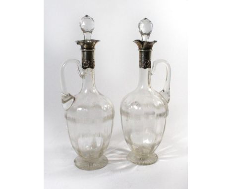 A Edward VII pair of silver mounted cut clear glass claret jugsWith pierced silver mount and loop handle, William Hutton & So