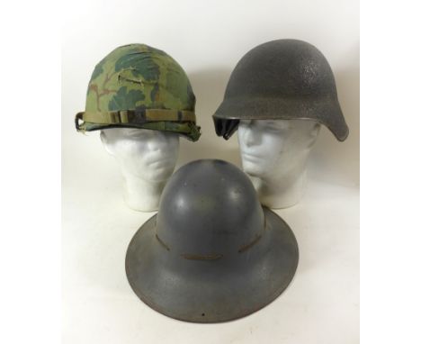A collection of three military helmets, mid 20th Century and later To include American Infantry mans helmet, complete with in