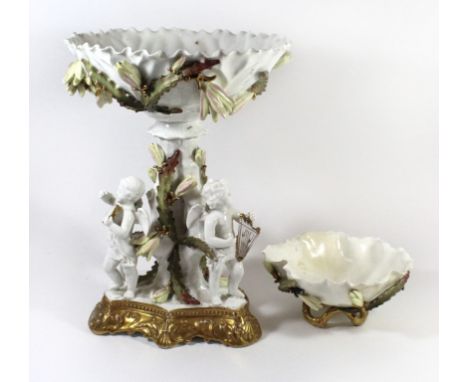 A large porcelain centrepiece vaseIn the style of Moore Brothers, with circular bowl over a trunk formed pedestal, with atten