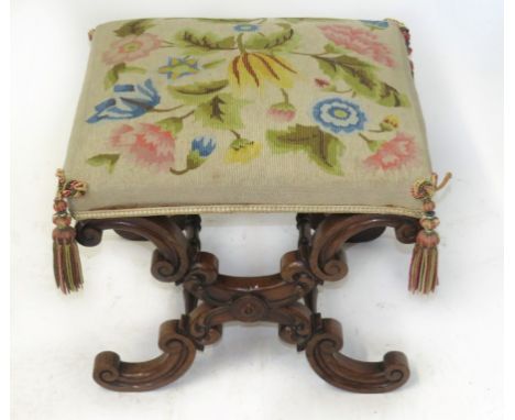 A Victorian footstoolThe tapestry covered top over a rosewood X-shaped frame, height 42cm, width 48cm, depth 43cm 