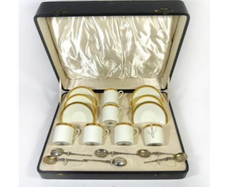 A cased set of six Royal Worcester gilt rimmed coffee cans and saucersPattern no. 1290 together with six accompanying silver 