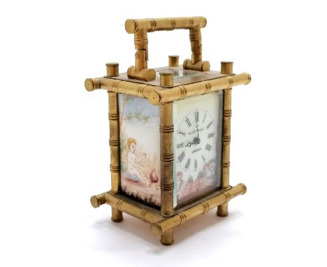 Elliott &amp; Son London miniature carriage clock with cherub detailed porcelain decorative panels and faux bamboo gilt brass