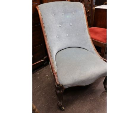 A Victorian carved rosewood frame button down upholstered nursing chair, circa 1860, on cabriole legs and castors.
