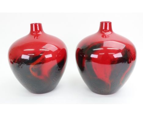 Two large Royal Doulton flambé veined vases, post 1970, each of carboy shape and with thick blue/grey swirling glaze on a red