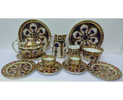 Forty-three pieces of Royal Crown Derby 1128 pattern teaware comprising twelve cups, saucers and plates, two large trays, a m