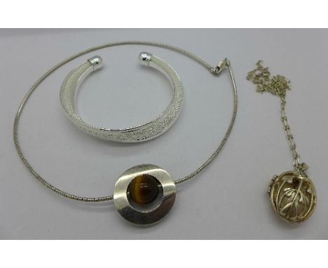 A silver and tigers eye necklet, a silver locket with chain and a bangle