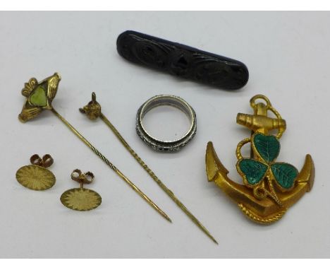 A jet brooch, a pair of yellow metal earrings, a 9ct gold and silver ring, two stick pins and an anchor brooch with green ena