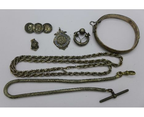 A silver bangle, a silver football fob, a silver 3d coin brooch, one other brooch, a pendant, a watch chain and a neck chain,