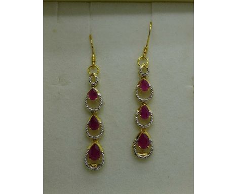 A pair of silver gilt set, ruby and diamond earrings