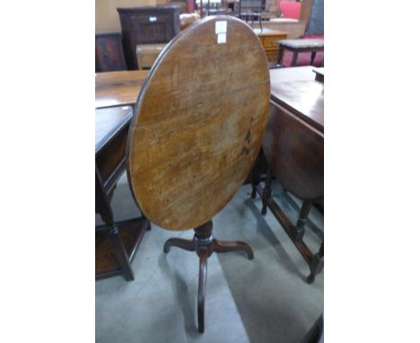 A George III oak circular tilt top tripod table 