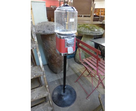 A vintage gumball vending machine, with key 