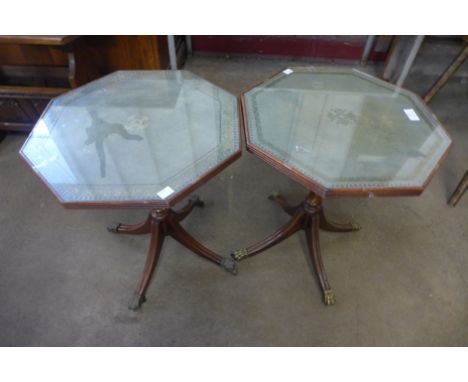 A pair of mahogany and green leather topped tripod wine tables 