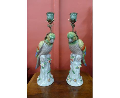 A pair of French style porcelain parrot candlestick holders 