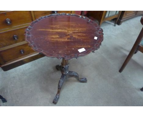 A Chippendale Revival carved mahogany birdcage action tilt top tripod table 