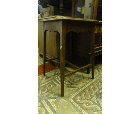 An Edwardian oak occasional or plant table of square cut form with inset tile top