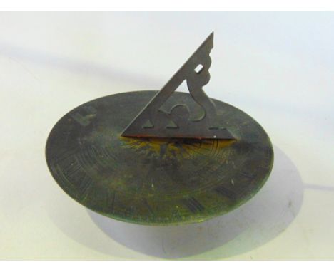 A cast brass sundial signed R Glynne.