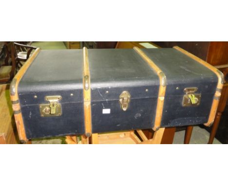 A vintage travel trunk with timber lathes and brass fittings together with a collection of theatre programmes