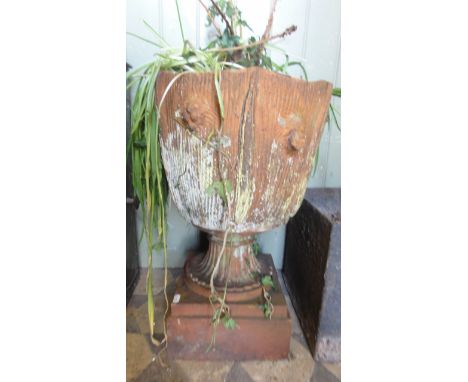 A vintage terracotta planter with naturalistic combed bark effect raised on a fluted pedestal and stepped base, stamped Royal