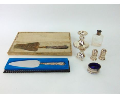 Single silver square candlestick, three piece condiment set and a further pepper pot, silver handled cake slice and one other