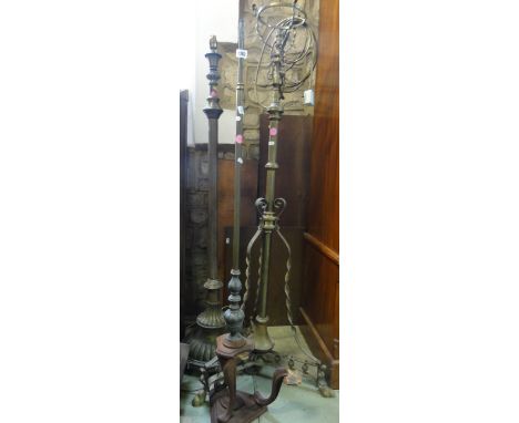 Three Victorian brass and iron lamp standards, further brass fender with geometric detail and a five canopy