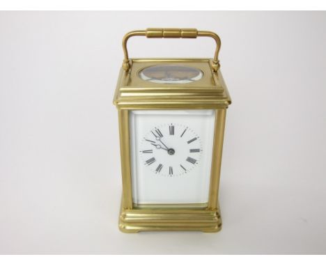 A gilt brass carriage clock striking on a gong within a gilt brass canalee case, the enamel front with Roman numerals, the cl