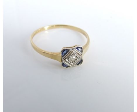 An 18ct gold and platinum Art Deco plaque ring set with four free cut sapphires and central old brilliant cut diamond, ring s