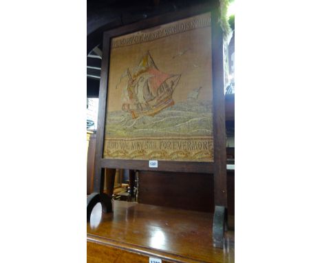 An Arts & Crafts drawn threadwork panel within an oak frame presented as a firescreen, the panel with script "we know the mer