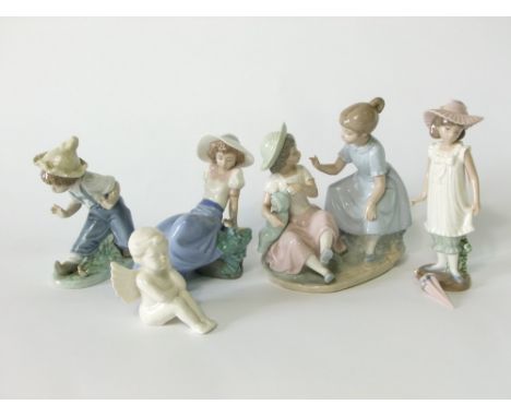 A collection of Lladro Daisa Nao groups including a pair of little girls with a doll, a boy and girl with birds and a little 