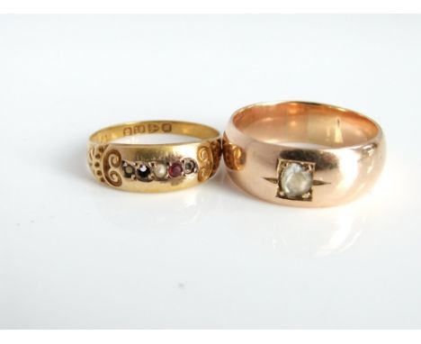 An 18ct gold split pearl and ruby cabochon ladies ring with decorated scrolling shoulders together with an unmarked yellow me