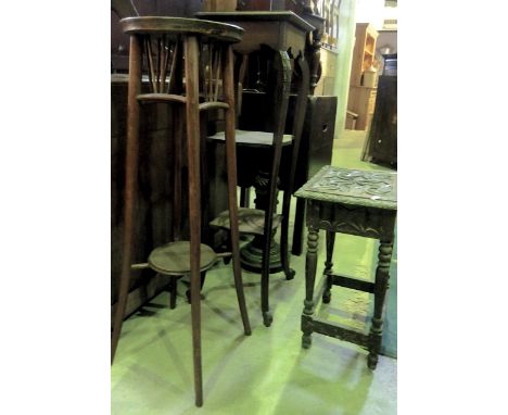 An Edwardian mahogany three tier torchere, a further torchere with circular top and a primitive carved hardwood occasional ta