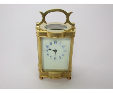 "Time Only" carriage clock within a serpentine gilt brass case with cobalt blue enamelled numerals and bevelled glass, the cl