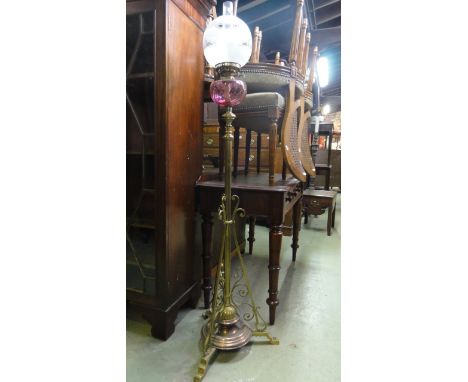 A late 19th century copper and brass telescopic lamp standard with cranberry coloured font and with etched glass shade and du