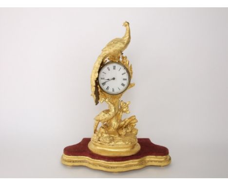 French gilt metal figural drum head mantle clock, the 9 cm enamel dial held aloft in the branches of a gilt tree surmounted b